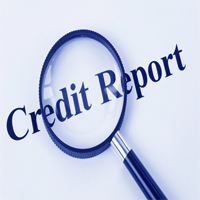 credit report text with a magnifying glass on top of it
